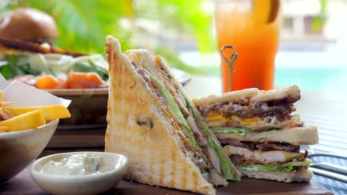 Grilled Bacon Lettuce and Egg Club Sandwich with Chicken on White Toast