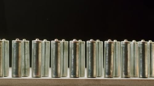 Shiny AA Batteries Aligned Upright on Flat Surface