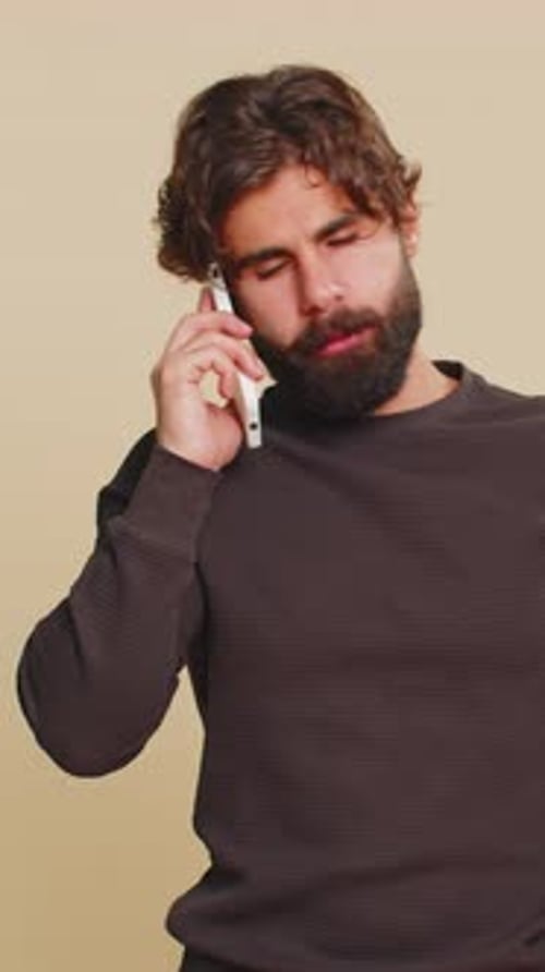 Young Adult With Brown Curly Hair Talking on Phone