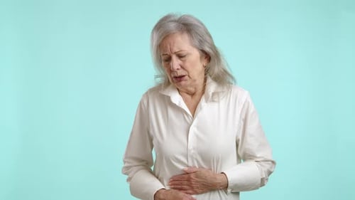 Senior Woman Experiencing Stomach Pain