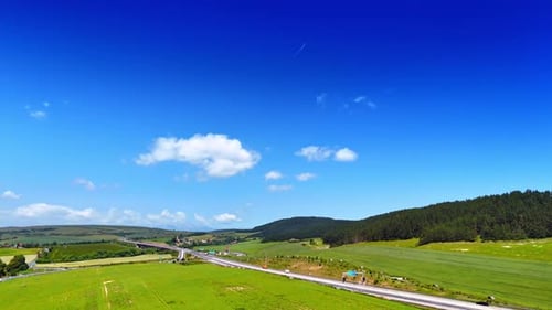 Mountain road winding through green forest hills.