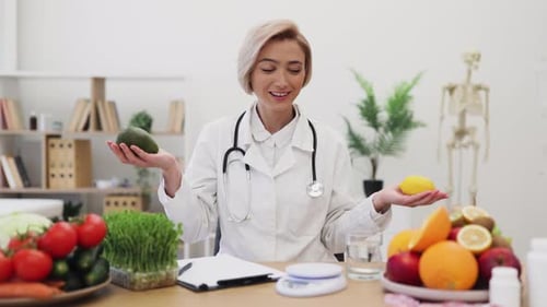 Nutritionist Holds Avocado and Lemon in Sunny Office