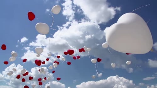 Red and White Heart Balloons Floating in Sky