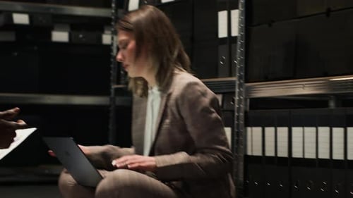 Business People Discuss Report Sitting on Floor