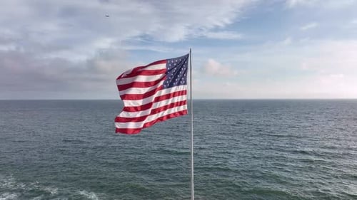 American Flag in Coastal Wind Flag Rippling in Ocean Air American Flag Fluttering Offshore American