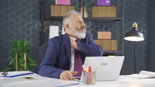 Man With Shoulder Pain at Office Desk
