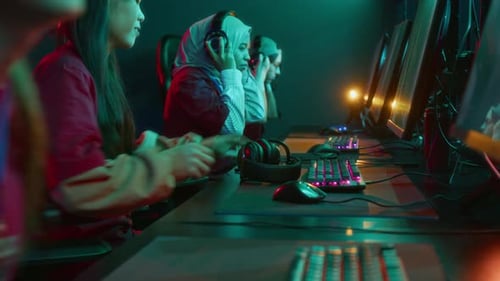 Young People Playing Computer Games in Dark Room