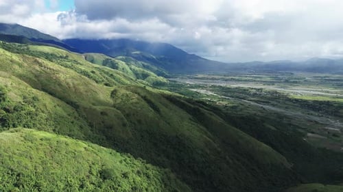 Fly over green landscape, cloudy day in the Philippines, Aurora province