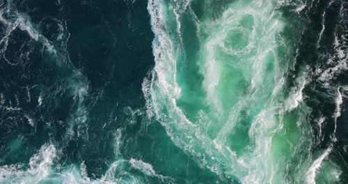 Blue waves of water of the river and the sea meet each other during high tide and low tide.