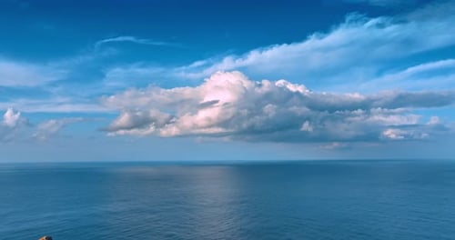 Ocean Meets Sky: Aerial View of Blue Water and Clouds
