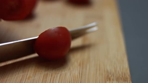 Fresh Cherry Tomatoes Sliced on a Wooden Board