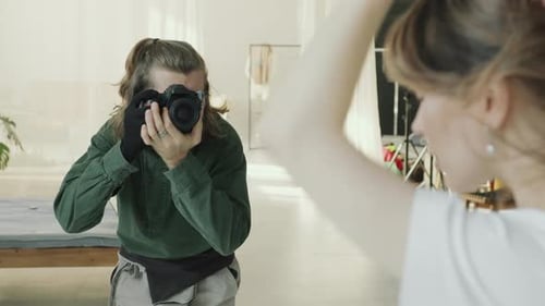 Photographer Capturing Portrait of Model in Modern Studio
