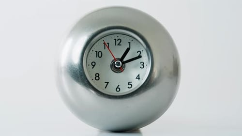 Metal Clock Ticking White Studio Space Closeup Hour and Minute Hands Moving