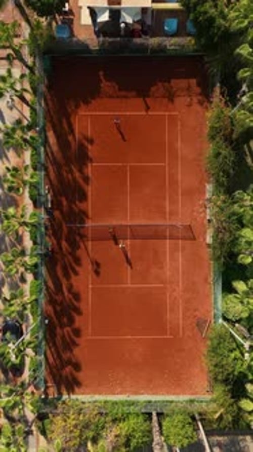 Vertical Video Tennis Delight Aerial Perspective of PalmEncircled Court in Paradise