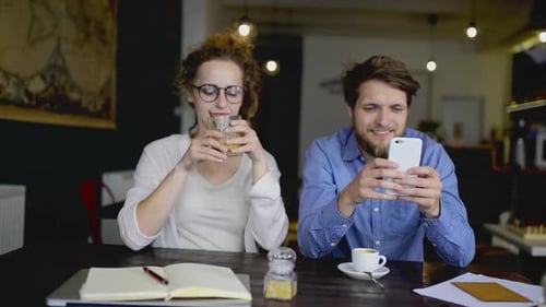 Two Young Designers on a Meeting in Cafe