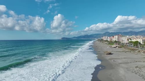 Aerial Video Ocean Storm with Big Waves and Dazzling Foam Patterns Along the Shore