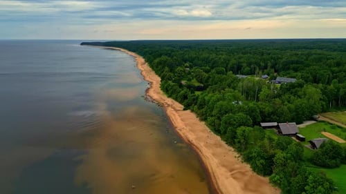 Drone aerial landscape of ocean sea coastline headland sandbar shallow beach with dense forest bushl