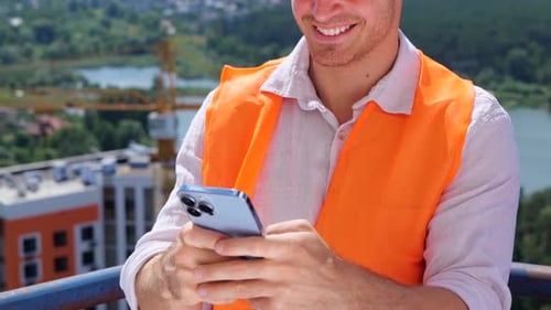 Construction Worker Using Smartphone at Construction Site