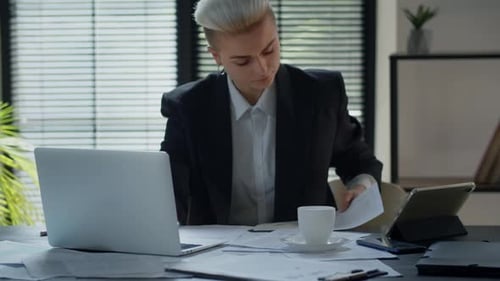 Young Adult Working at Desk With Laptop
