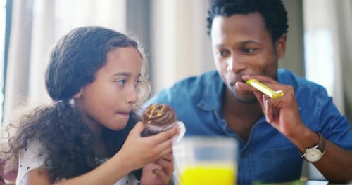 Father and Daughter Share a Delicious Cupcake at Home
