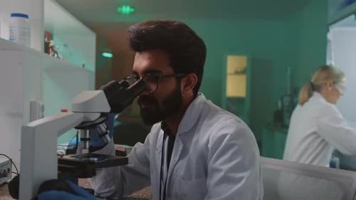 Scientist Using Microscope in Bright Laboratory
