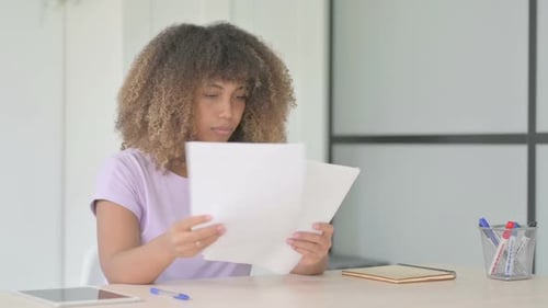 Woman Looking Upset While Reading Papers