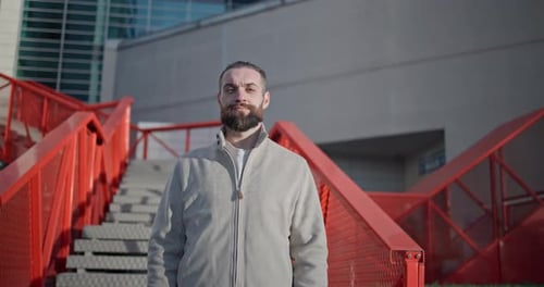 Confident Bearded Man Posing on Urban Stairs