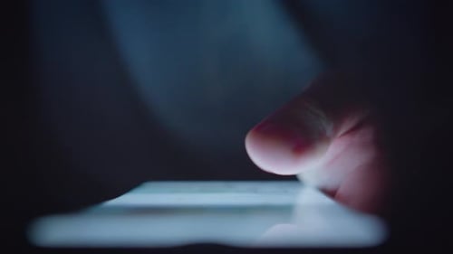 Man Scrolling Mobile Phone at Night, Close Up of Thumb Using App