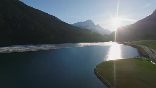 Aerial View of the Snow Rocky Cliffs with Forest By the Lake
