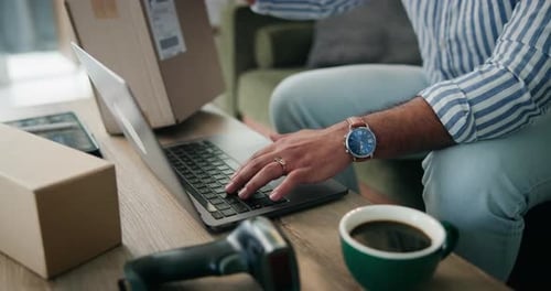 Typing on Computer with Boxes and Coffee