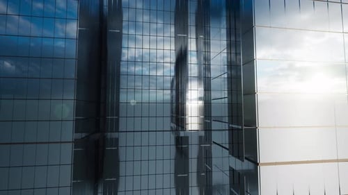 Modern Glass Skyscraper Exterior With Sunshine And Reflection On The Windows