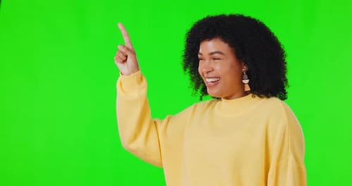 Pointing finger, happy woman and green screen for advertising space, announcement or promotion
