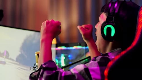 Asian Boy Streamer Celebrating Winning Game On Computer. Live Stream Video Game