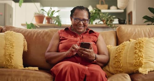 Woman Using Smartphone on Couch at Home