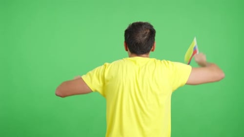 Rear View of a Man Waving a Colombian Pennant