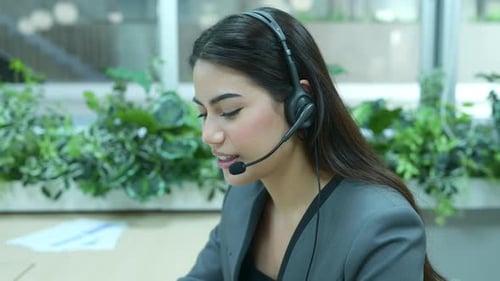 Young female working at a call center which is a consultant for various information of customers