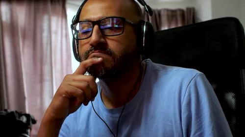 Man with Headphones Focused Indoors