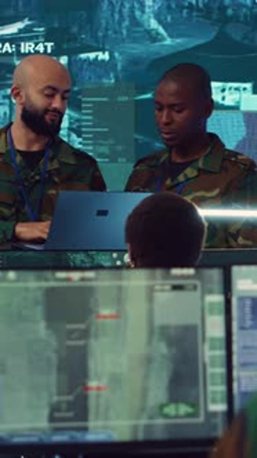 Men in Camouflage Work at Monitors