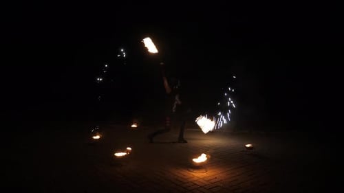Fire Performer Dancing at Night