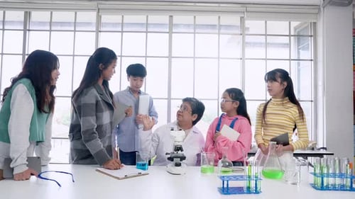 Students Learning Science with Teacher in Classroom Lab