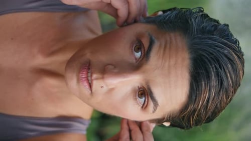 Woman Inserts Wireless Earbuds in Nature