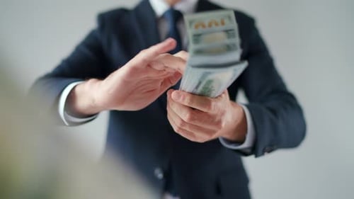 Formally Dressed Man Makes Money Rain From US Dollar Bills