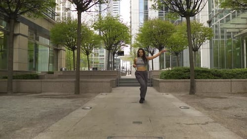 Confident breath taking model dancer hip hop street is cat walking forward dominating her space dres