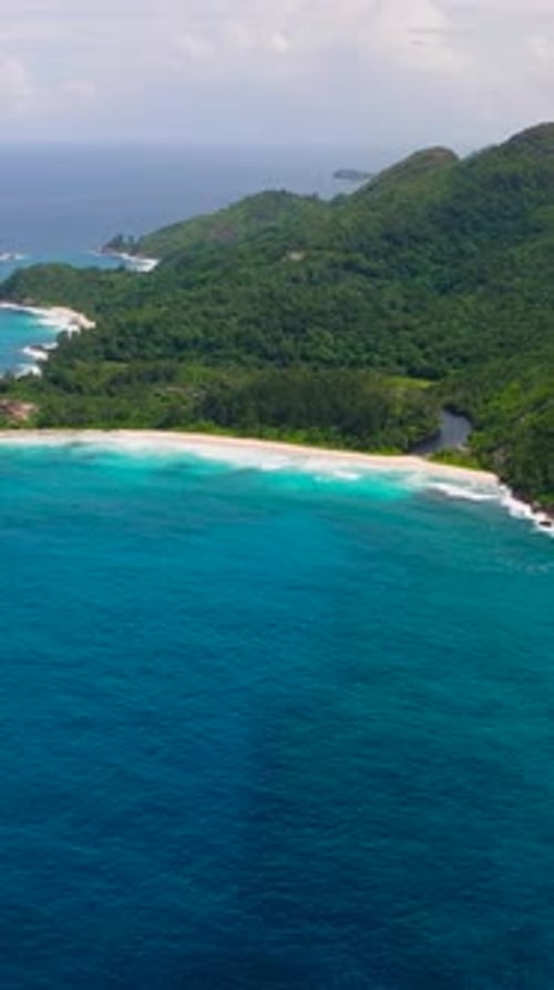 Pristine Tropical Bay with Turquoise Water and Lush Hills Seychelles Mahe