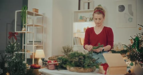 Woman Preparing Christmas Wreath Garland For Christmas Holidays