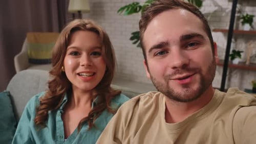 Happy Couple Waving During Friendly Video Call