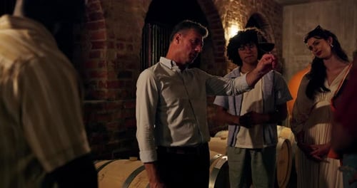 People Tasting Wine in a Rustic Wine Cellar