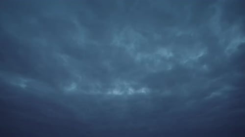 Timelapse view of a dark blue sky with moving clouds