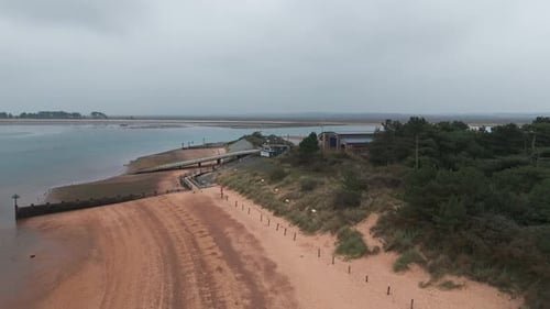 Aerial view of the beach, dunes, and pier at Wells-next-the-Sea on an overcast day