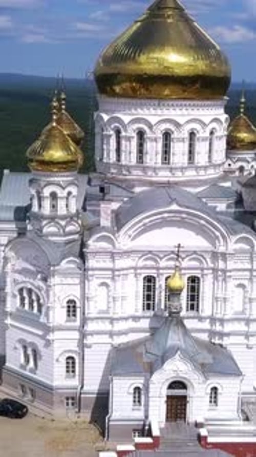 Huge White Church Drone View Clip A Green Landscape with a Temple with Golden Domes Standing in the